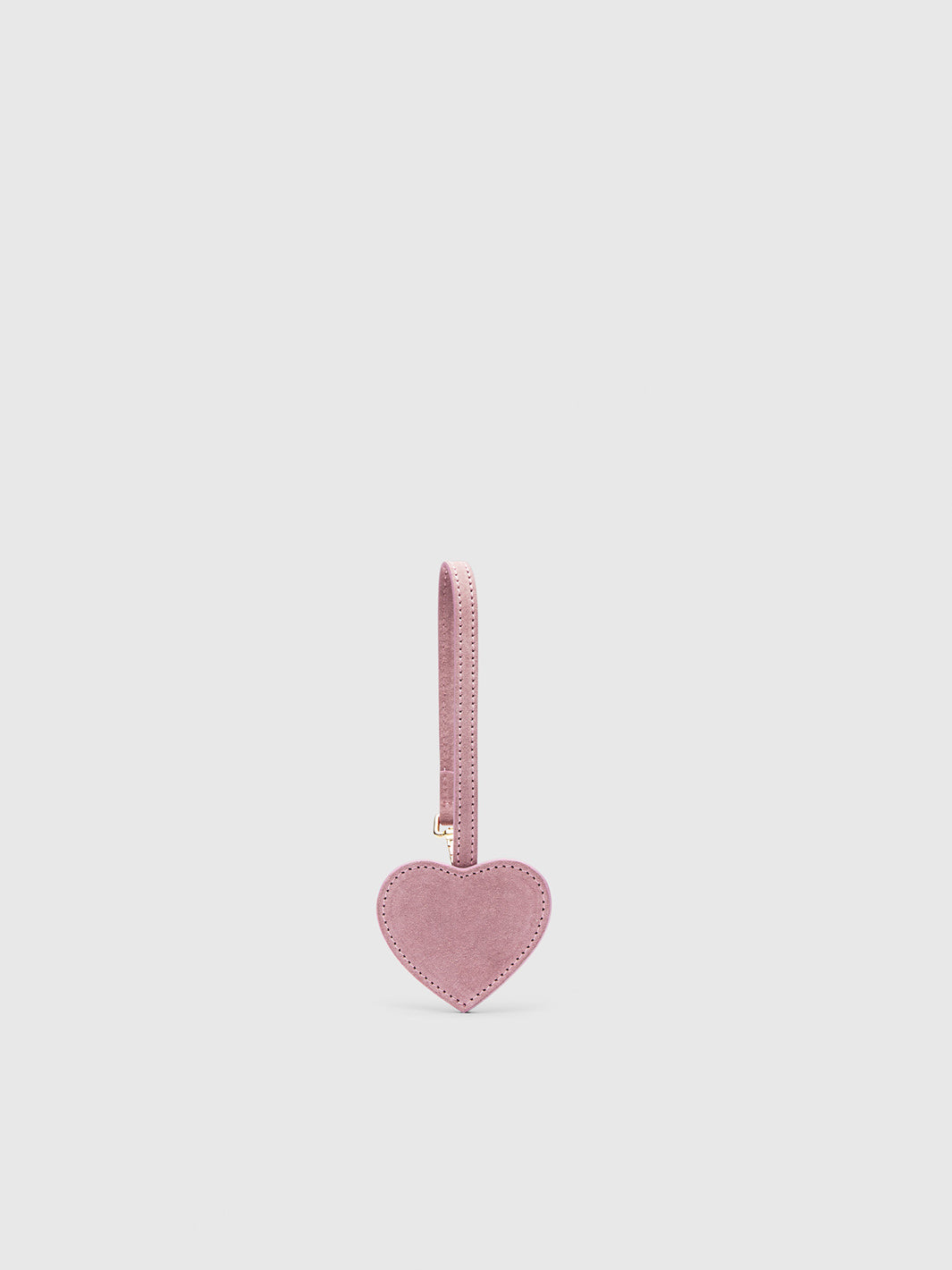 A dusty pink heart-shaped suede keychain with a matching strap, shown against a solid light gray background.